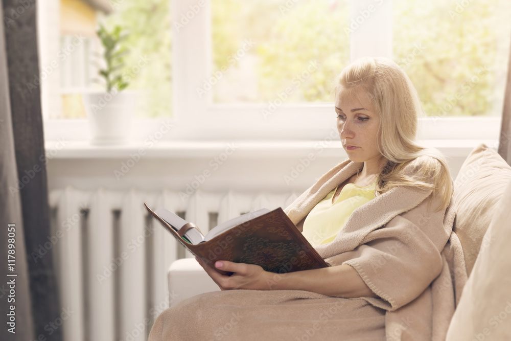 woman resting on the couch and read a book woman resting on the couch and read a book