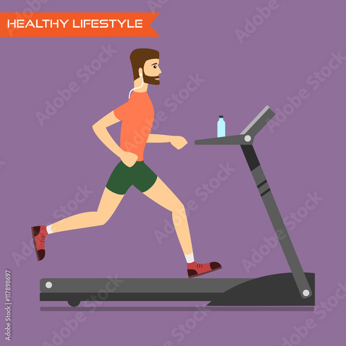 Young man running on treadmill.