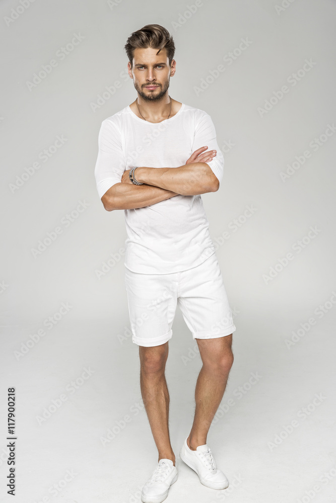 Handsome male model with arms crossed wear white clothes