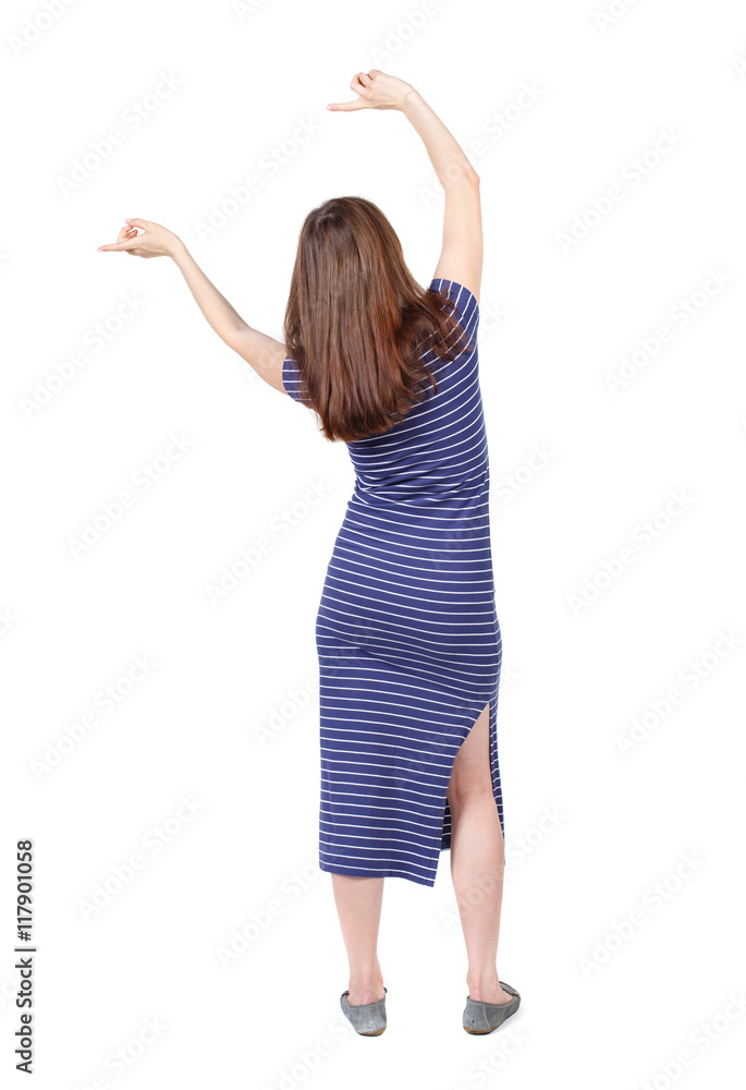 back view of dancing young beautiful woman. girl watching. Rear view people collection. backside view of person. Isolated over white background.The brunette in a blue striped dress waving his back view of dancing young beautiful woman. girl watching. Rear view people collection. backside view of person. Isolated over white background.The brunette in a blue striped dress waving his