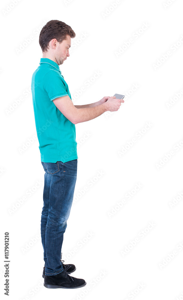 back view of business man uses mobile phone. rear view people collection. Isolated over white background. backside view of person. Curly man in a turquoise jacket stands sideways and playing on back view of business man uses mobile phone. rear view people collection. Isolated over white background. backside view of person. Curly man in a turquoise jacket stands sideways and playing on