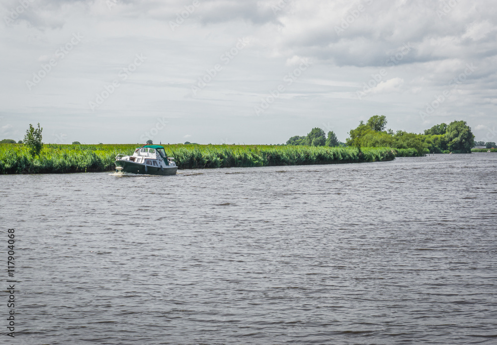 Fototapeta premium boat sailing in a river landscape 2