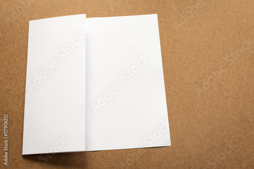 White paper note on business wood desk with copy space.