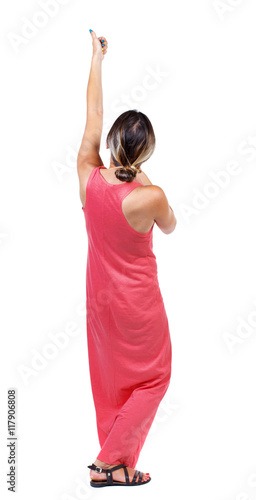 back view of standing girl pulling a rope from the top or cling to something. girl watching. Rear view people collection. backside view of person. Isolated over white background. A slender woman in