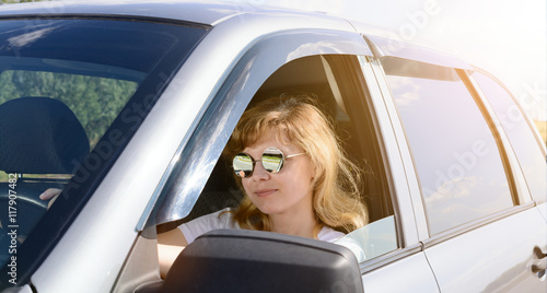 The woman in sunglasses driving a car