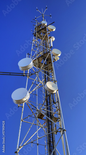 Communication antenna tower on blue sky