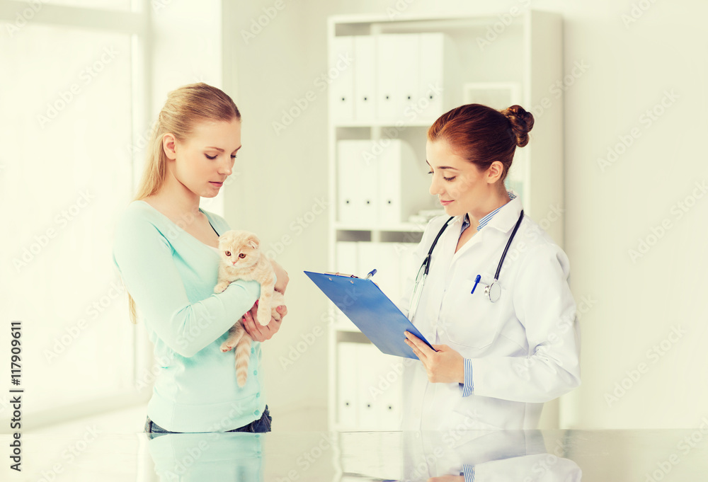 woman with cat and doctor at vet clinic