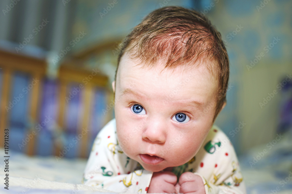 newborn baby lying on stomach and holds head newborn baby lying on stomach and holds head