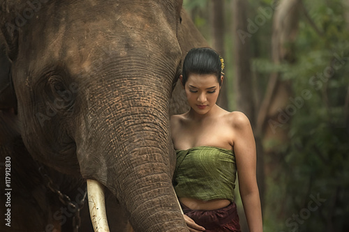 Photography Asia woman and elephant with Thai culture traditional.