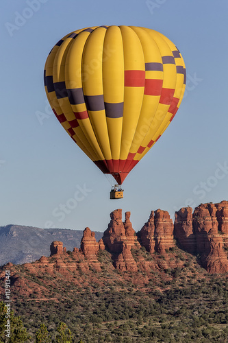Hot air balloon rising just after sunrise in Sedona, Arizona