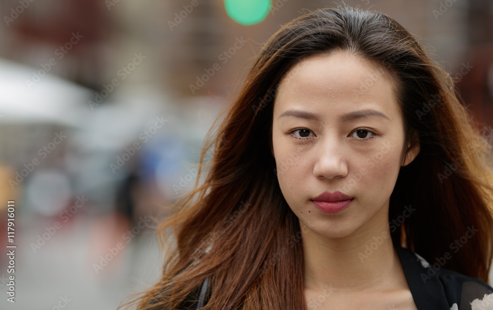 Obraz premium Young Asian woman in city serious face portrait