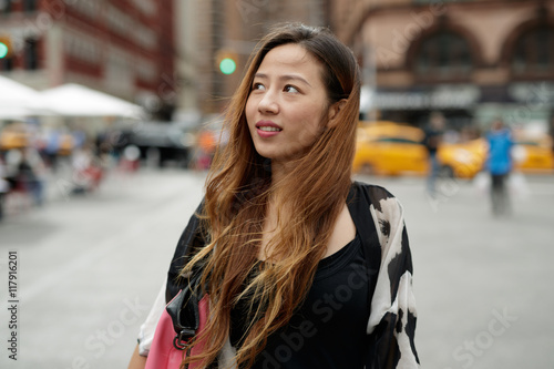 Young Asian woman in city walking smile happy face 