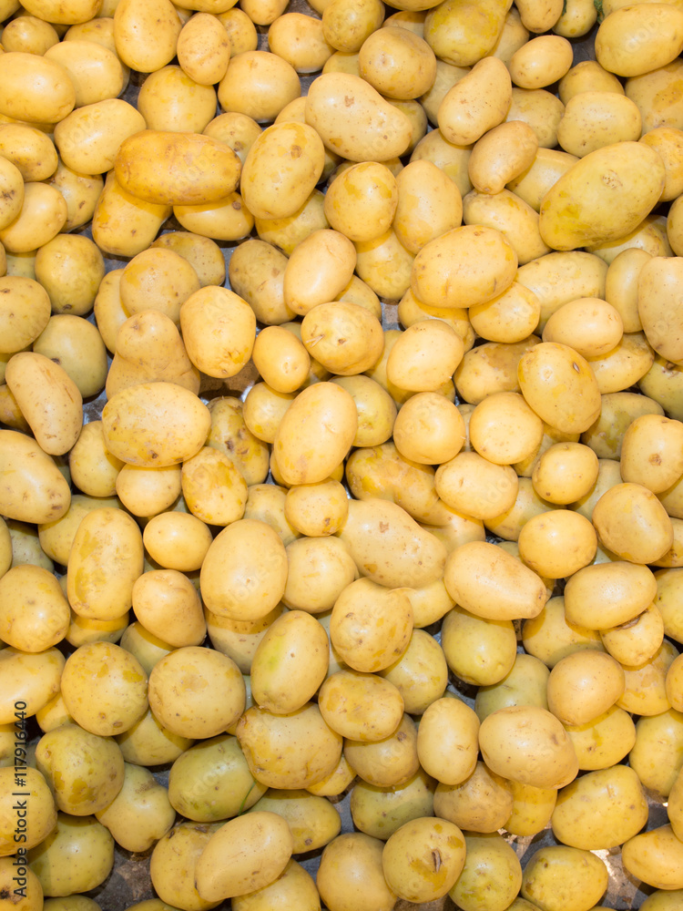 Potatoes on market. Yellow on background Potatoes on market. Yellow on background