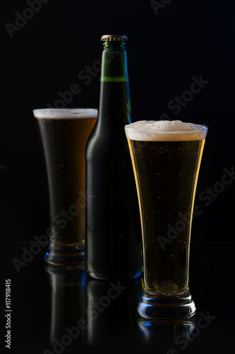 beer in a bottle and a glass on a dark background 