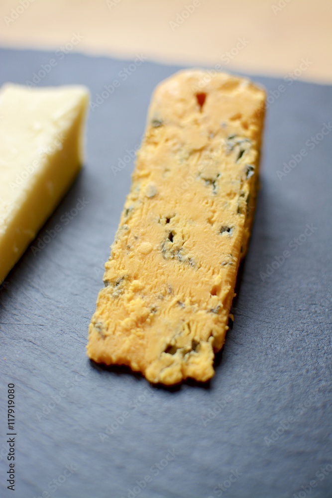Strong yellow cheese on a slate 