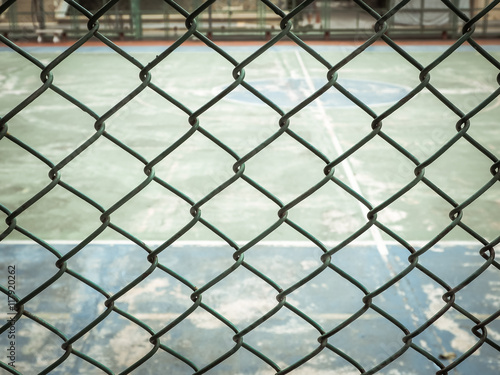Color retro image, Outdoor sport court behind Green wired fence