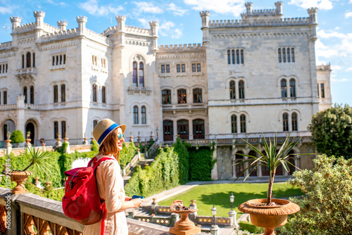 Young female traveler enjoying beautiful landscape near Miramare castle in northeastern Italy. Traveling in Italy