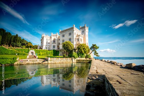 View on Miramare castle on the gulf of Trieste on northeastern Italy. Long exposure image technic with reflection on the water photo