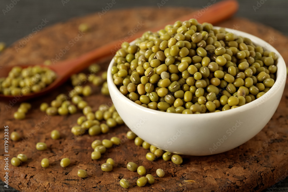Bowl filled with mung beans on wooden background Bowl filled with mung beans on wooden background