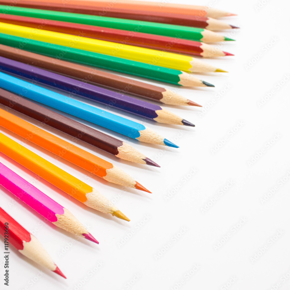 Multicolored pencils on white background. Schoolchild and student studies accessories. Back to school concept. Multicolored pencils on white background. Schoolchild and student studies accessories. Back to school concept.