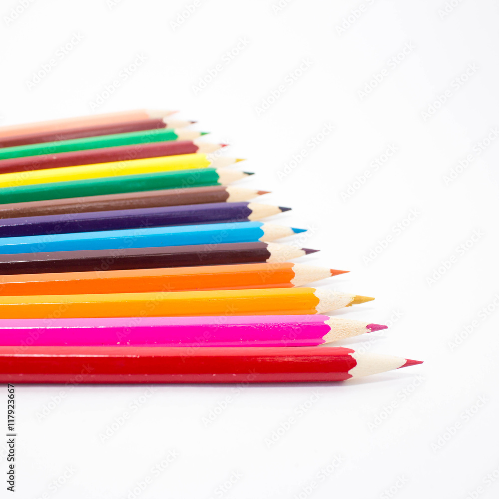 Multicolored pencils on white background. Schoolchild and student studies accessories. Back to school concept. Multicolored pencils on white background. Schoolchild and student studies accessories. Back to school concept.