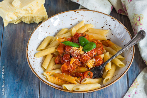 Penne pasta and arrabbiata sauce with cherry tomatoes