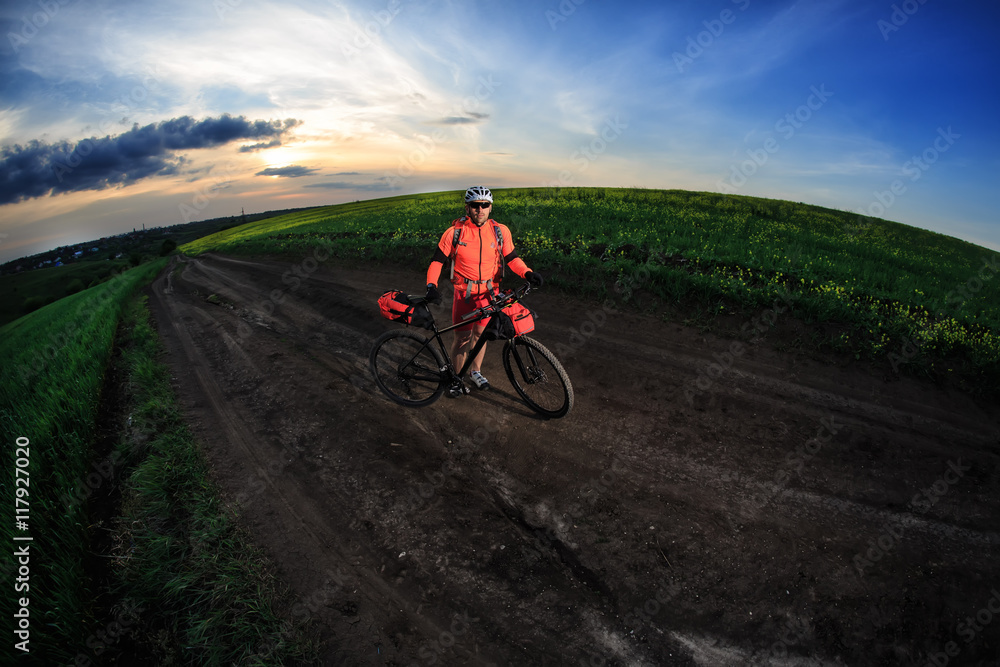 Tourist with backpack travels by bicycle