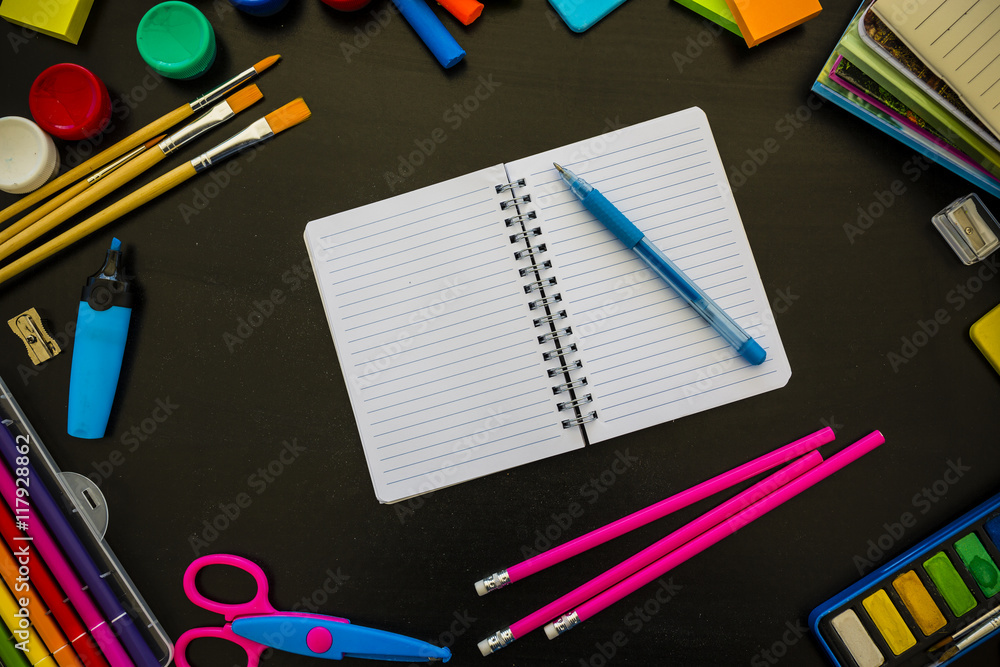 School supplies on blackboard background School supplies on blackboard background