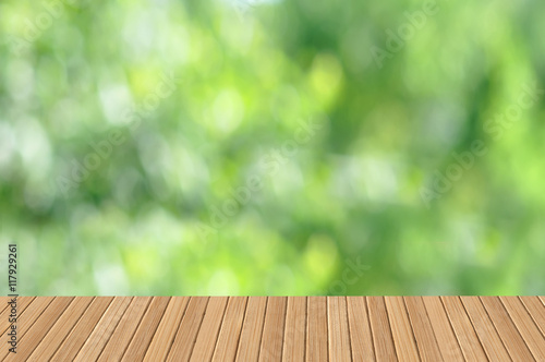 Empty wooden table with garden bokeh outdoor theme background