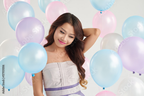 Portrait of smiling girl among colorful balloons