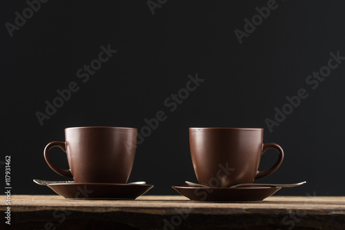 coffee cups, beans and sugar on rustic wooden table background 