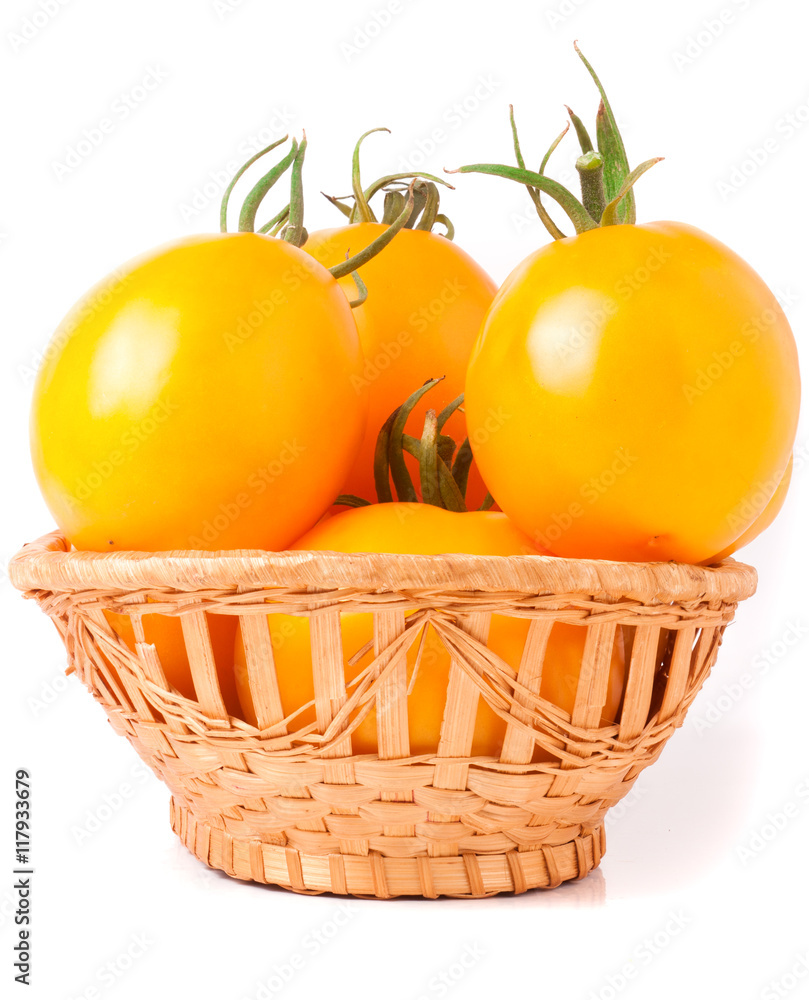 yellow tomatoes in a wicker basket isolated on white background yellow tomatoes in a wicker basket isolated on white background
