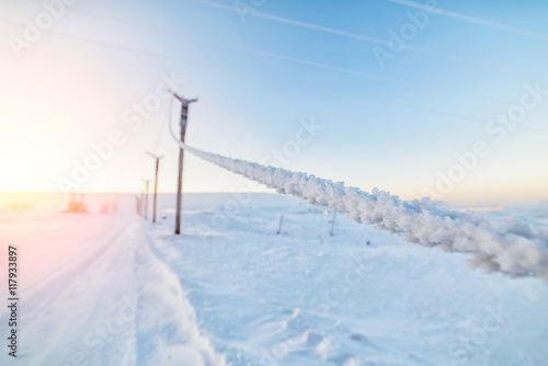 Electrical cable covered with a layer of frost.