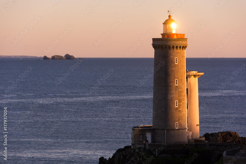 Lighthouse in the Atlantic ocean at sunset