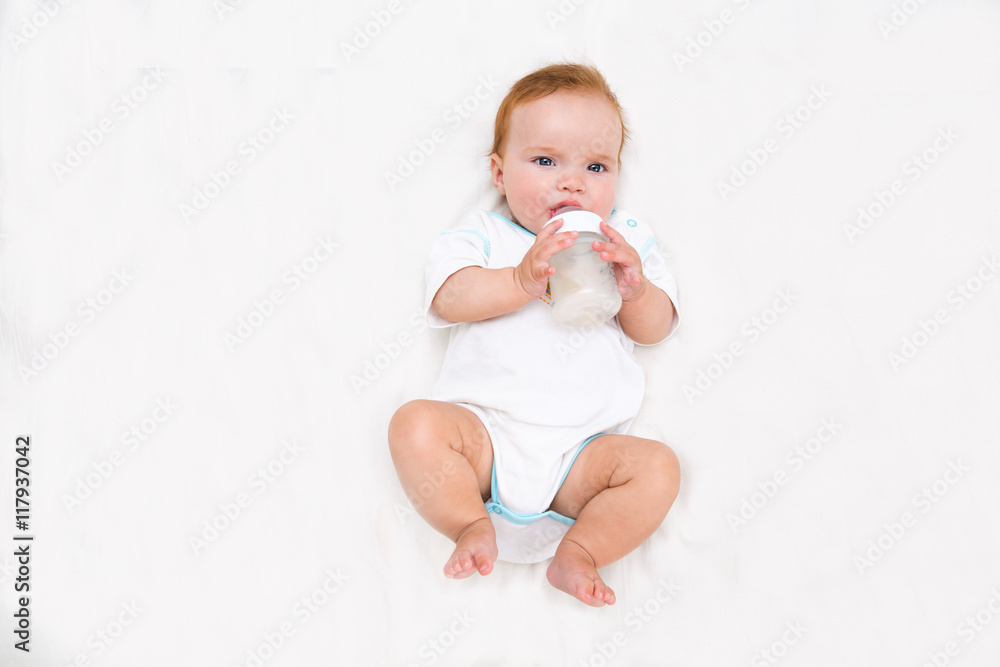 baby holding bottle and drinking water
baby holding bottle and drinking water