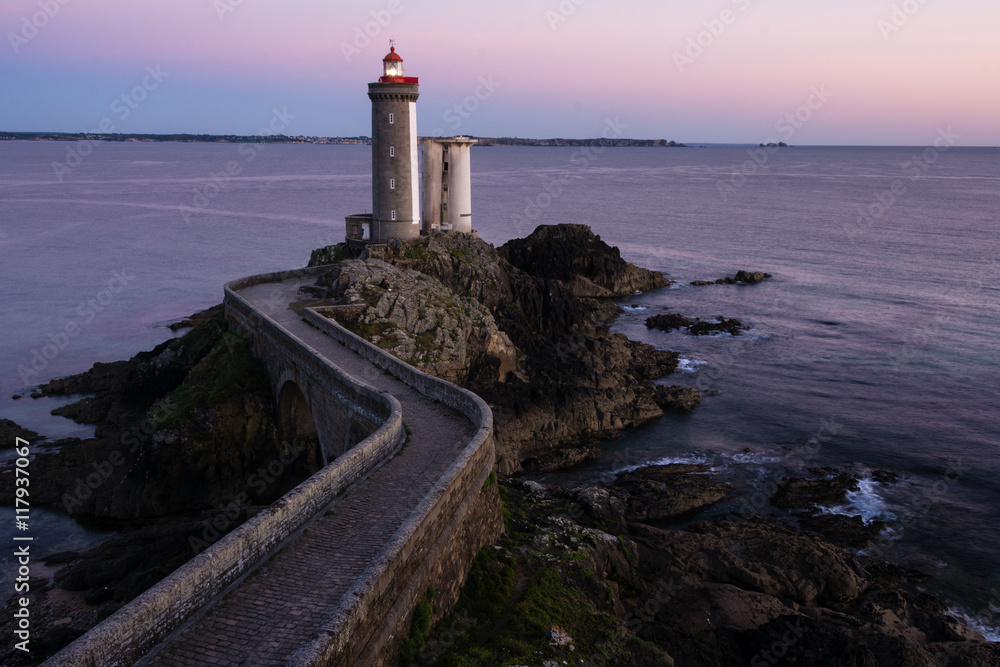 Lighthouse in the Atlantic ocean at dusk