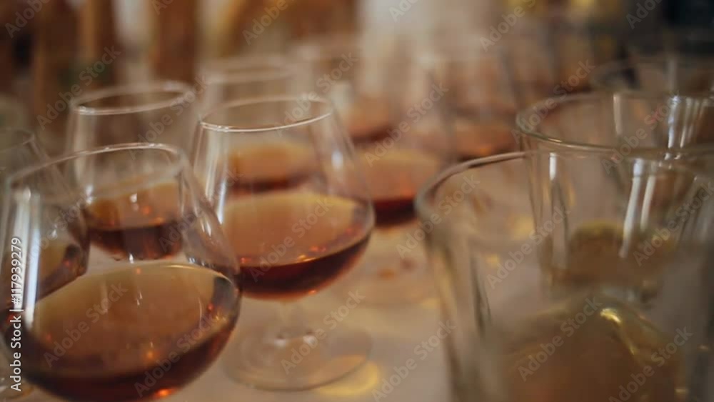 Different alcohol drinks in goblets and wine glasses on wedding buffet table Different alcohol drinks in goblets and wine glasses on wedding buffet table