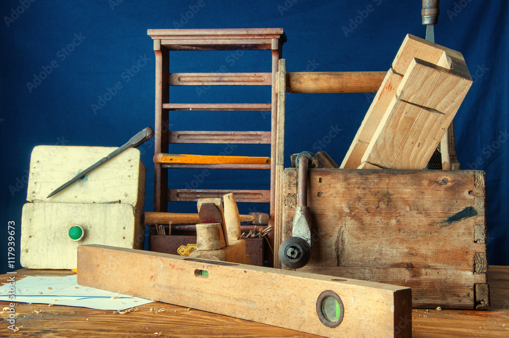 Equipment carpenter on a wooden desk with plans Equipment carpenter on a wooden desk with plans