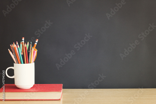 School items in front of a blackboard - vintage back to school concept