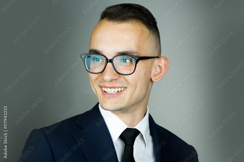 Smiling young guy in glasses