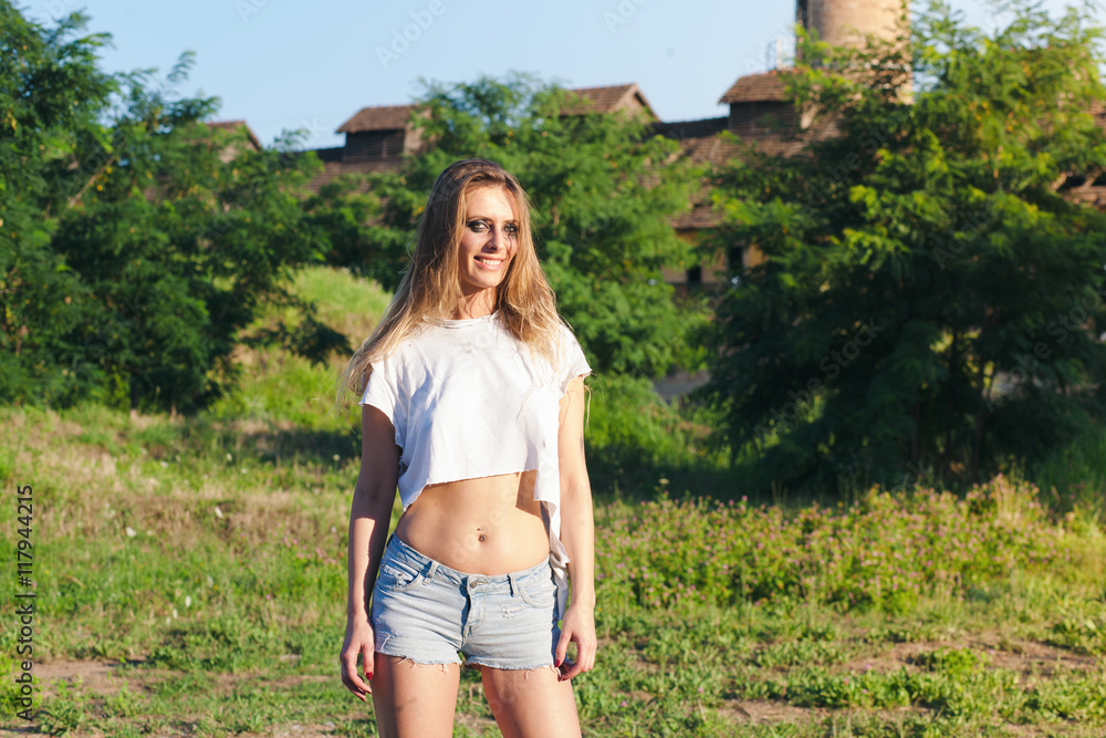 young woman in torn t shirt posing in nature young woman in torn t shirt posing in nature
