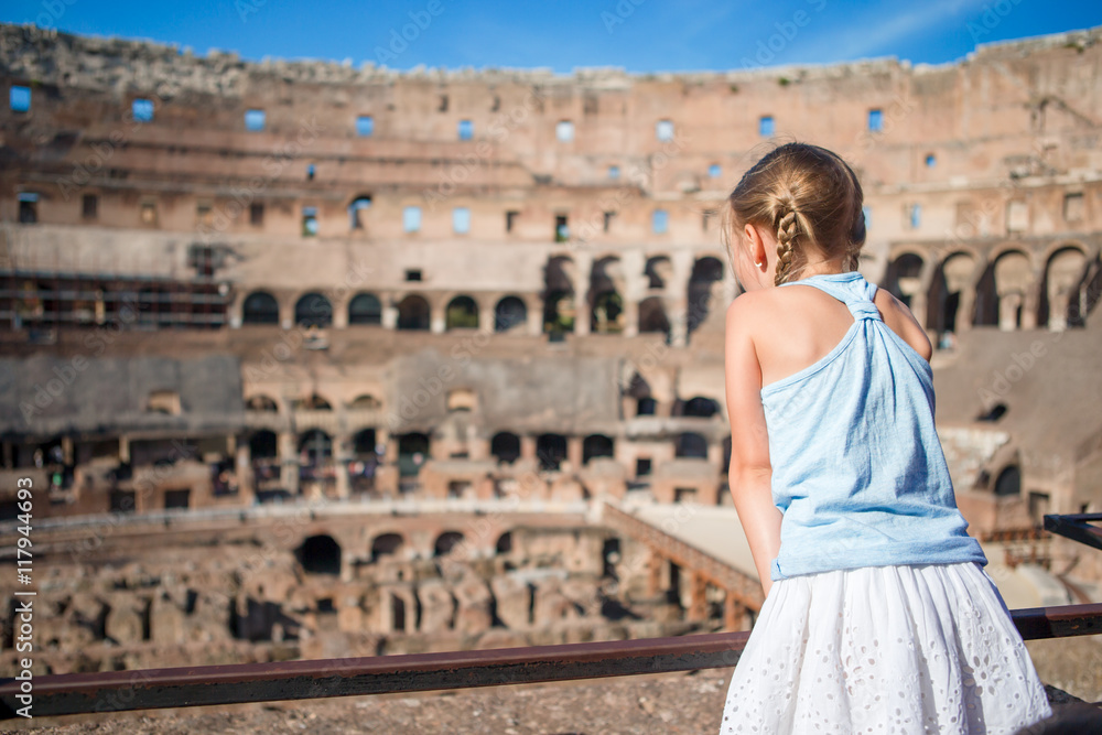 Little girl in Coliseum, Rome, Italy. Back view of kid looking at famous places in Europe