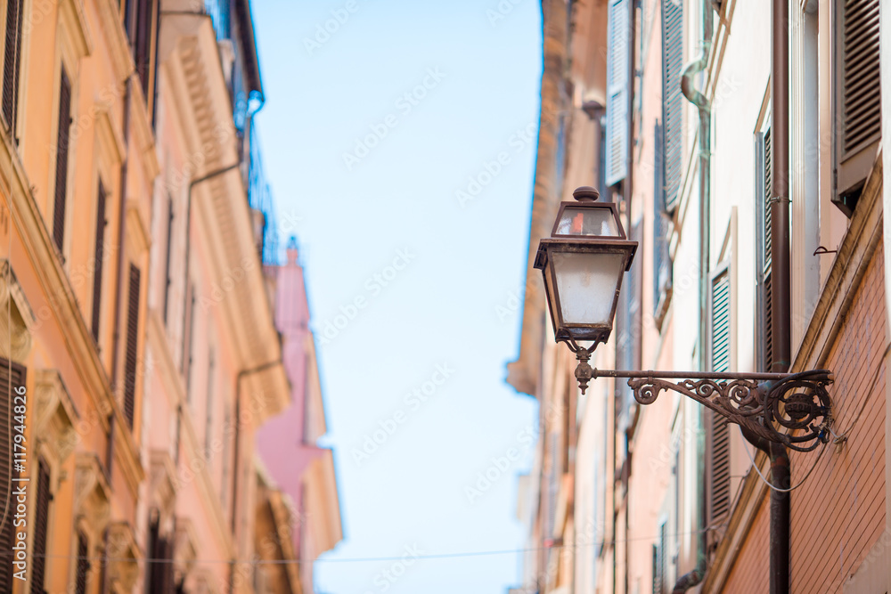 Old beautiful empty streets in Rome, Italy. Close-up of a street light at the town house