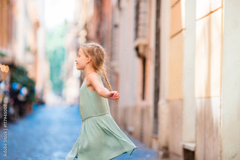 Adorable happy little girl outdoors in european city. Caucasian kid enjoy summer vacation in Rome
