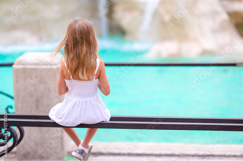 Photography Adorable little girl looking to the Fountain of Trevi in Rome