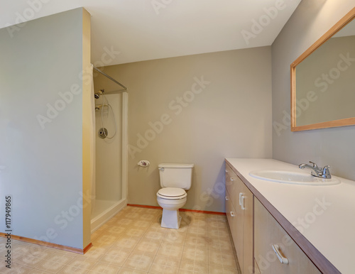 Simplistic bathroom with shower  toilet and vanity cabinet.