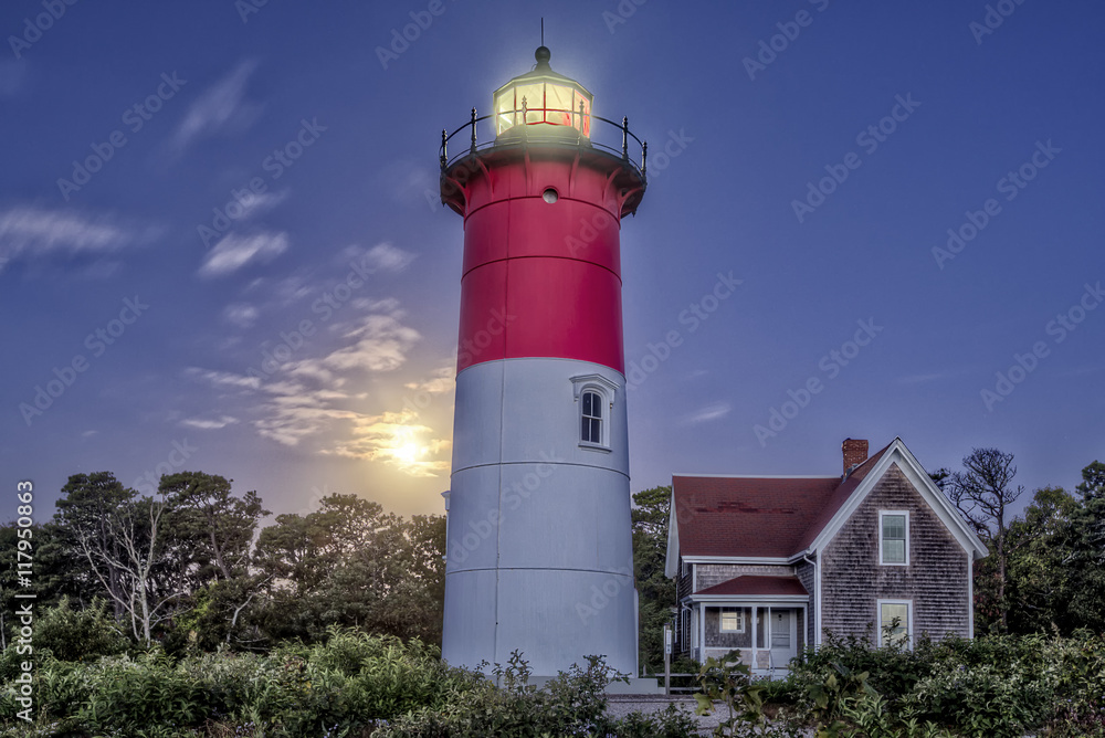 The Nauset Light about 20 minutes before sunrise with a Super Moon setting in the background.