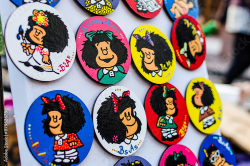 Colorful fridge magnets with Mafalda comics cartoon character at a weekend fair in San Telmo neighborhood, Buenos Aires.  photo