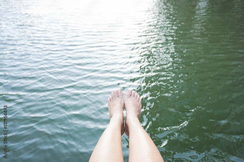 Fototapeta premium concept of relaxation by putting legs into water