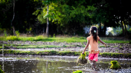 Little Child girl working in the field in Laos Nature Travel